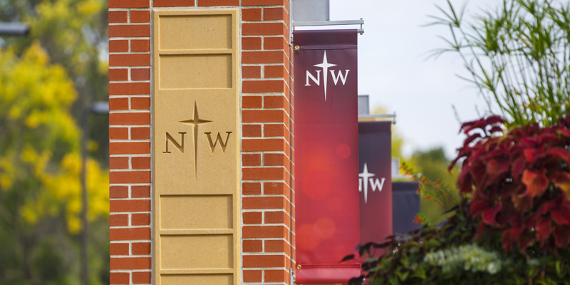 Northwestern banners hanging on brick pillars