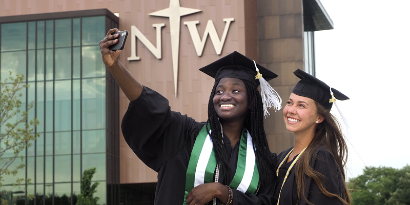 Two graduates taking a photo together