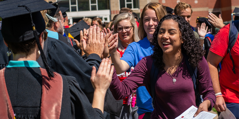 Students and faculty greeting one another