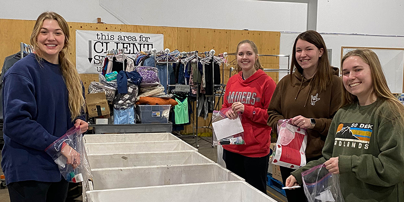 Students sort hygiene supplies at a food distribution center