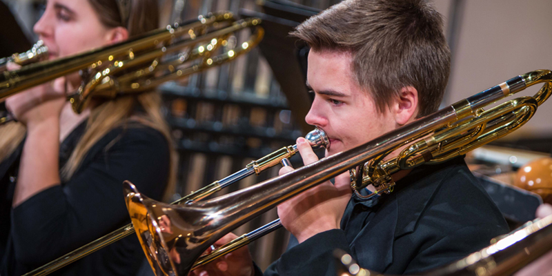 Student playing a trombone