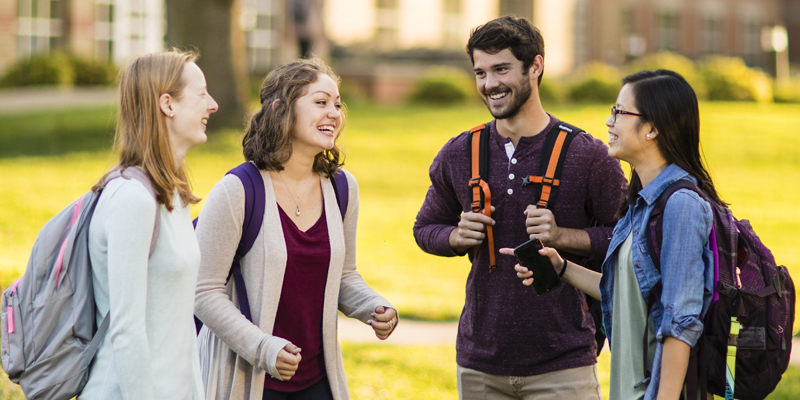 Four Northwestern students talking on campus