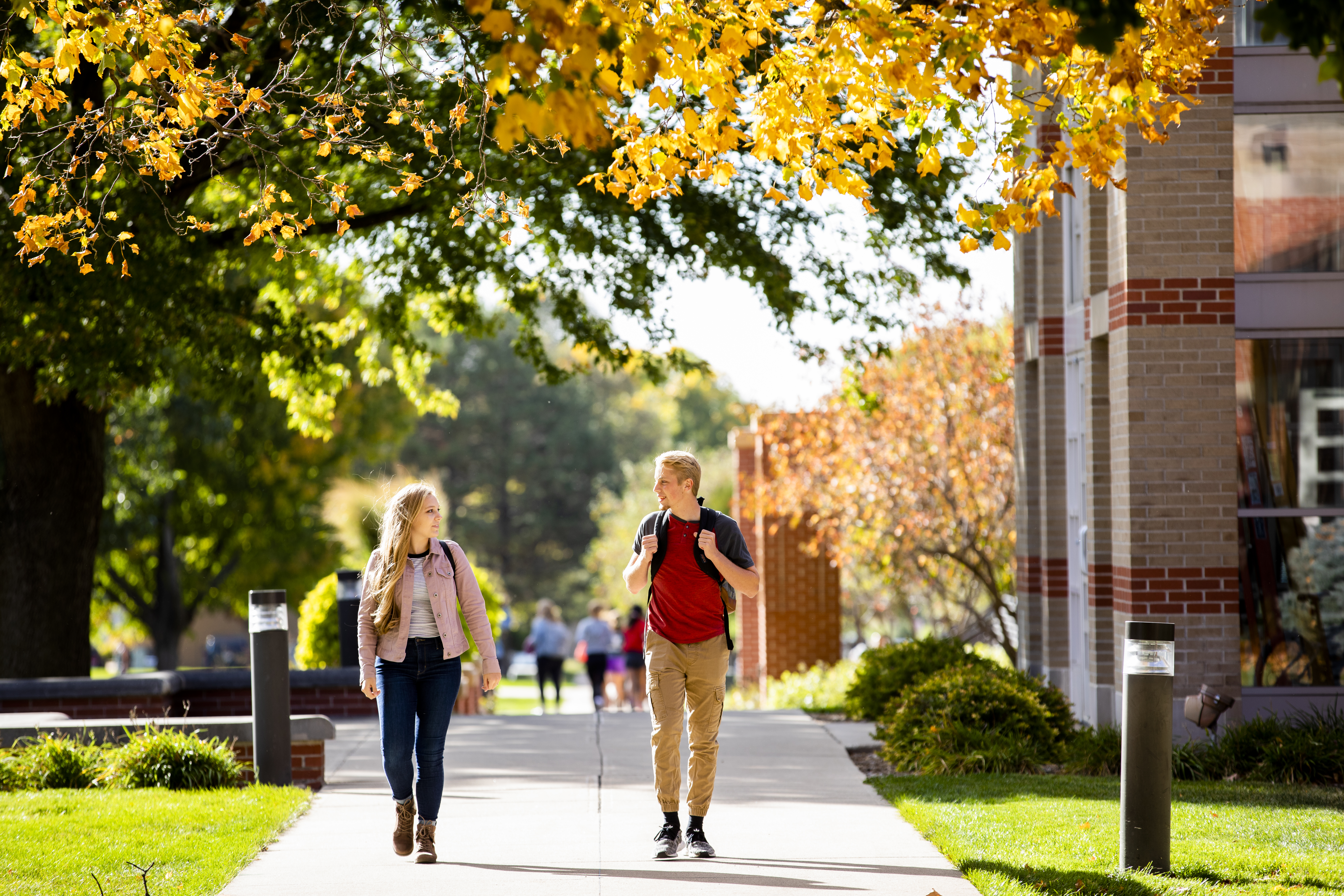 Students walking by chapel in the fall