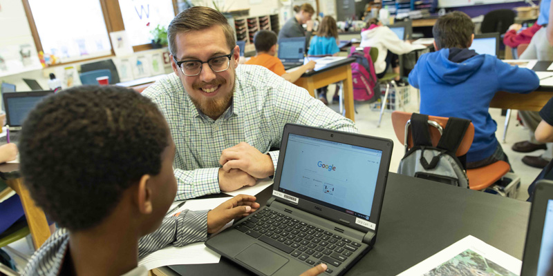 Teacher working with elementary student