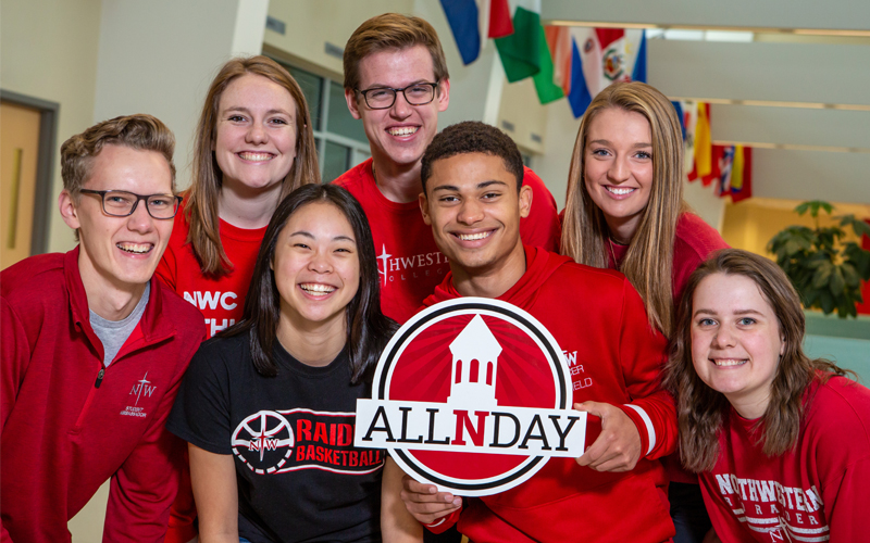 Students holding an AllNDay logo