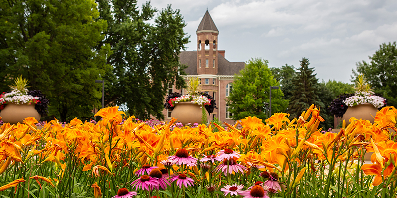 Zwemer Hall with summer flowers blooming
