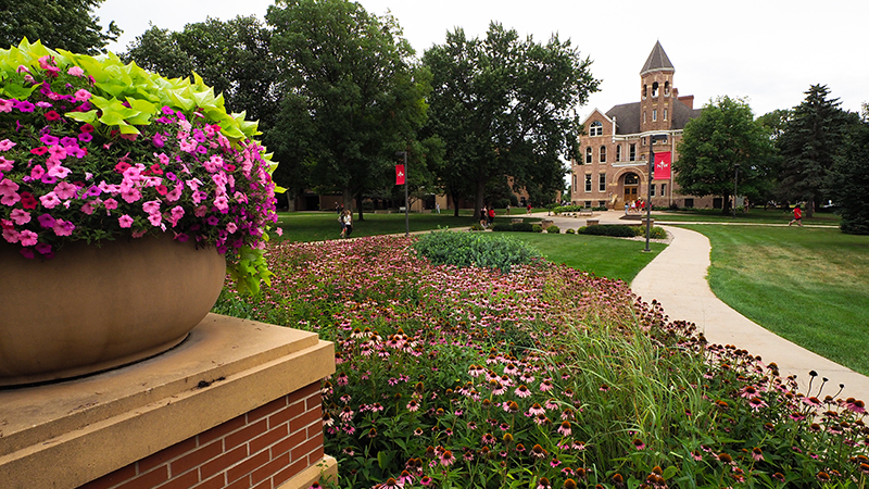 Campus green in summer with Zwemer Hall in background