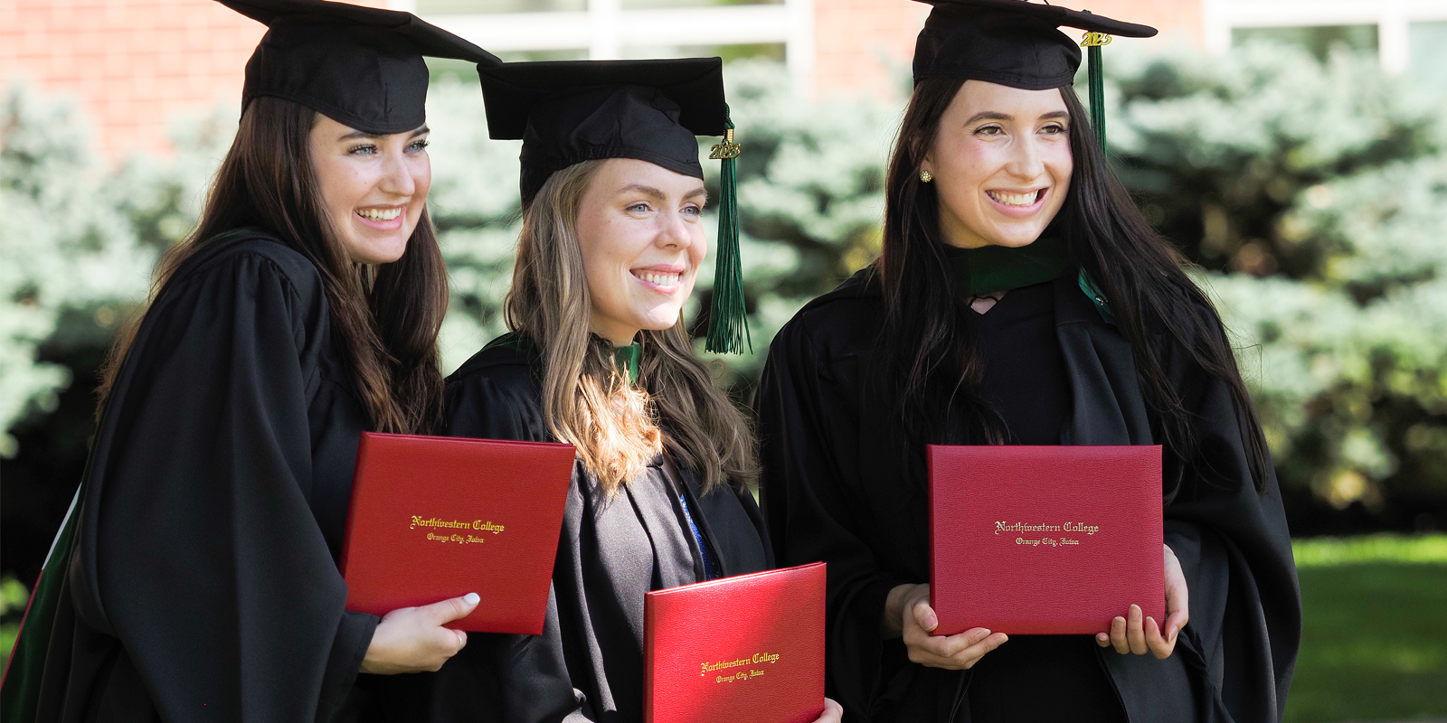 Physician assistant graduates pose for a photo with their diplomas