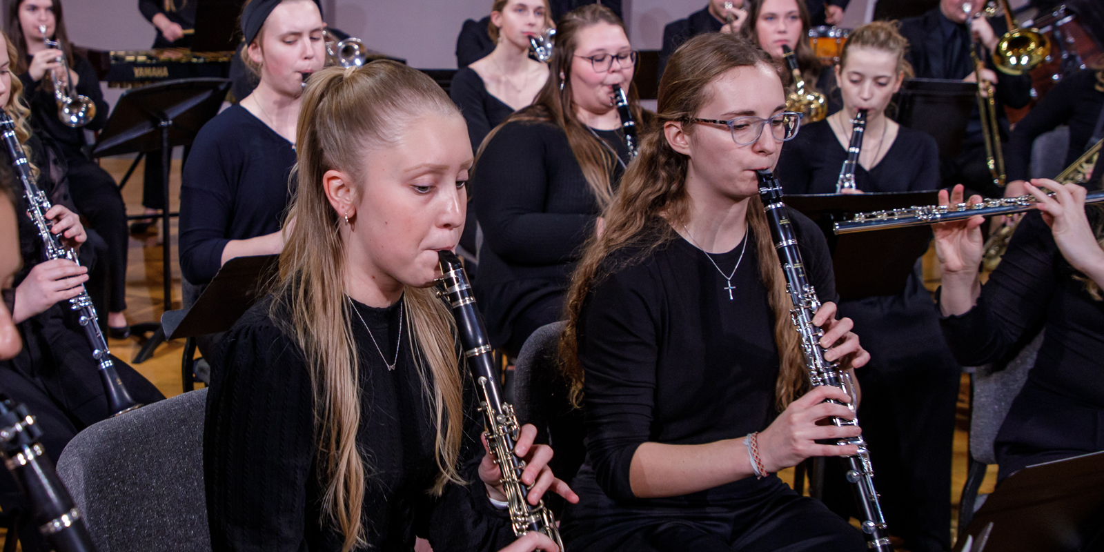 Two student clarinet players perform with the Symphonic Band