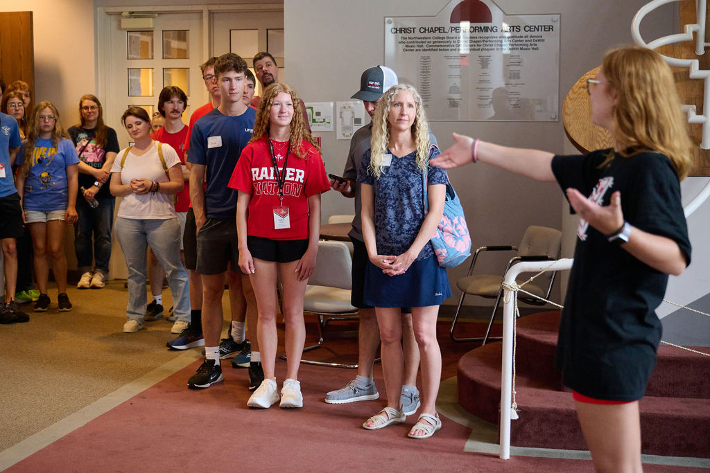 A student gives a campus tour to incoming freshmen and their parents