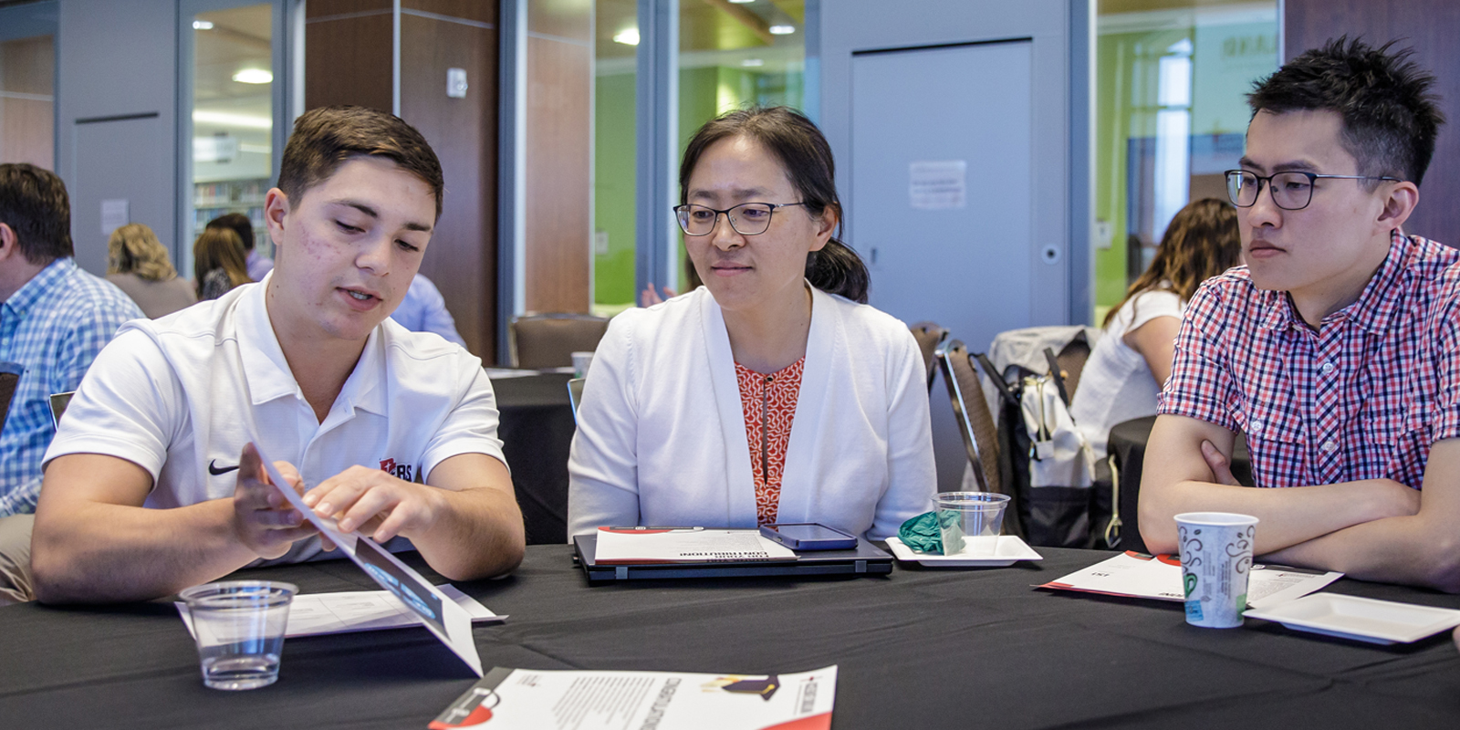 A student and two professors take part in a discussion group