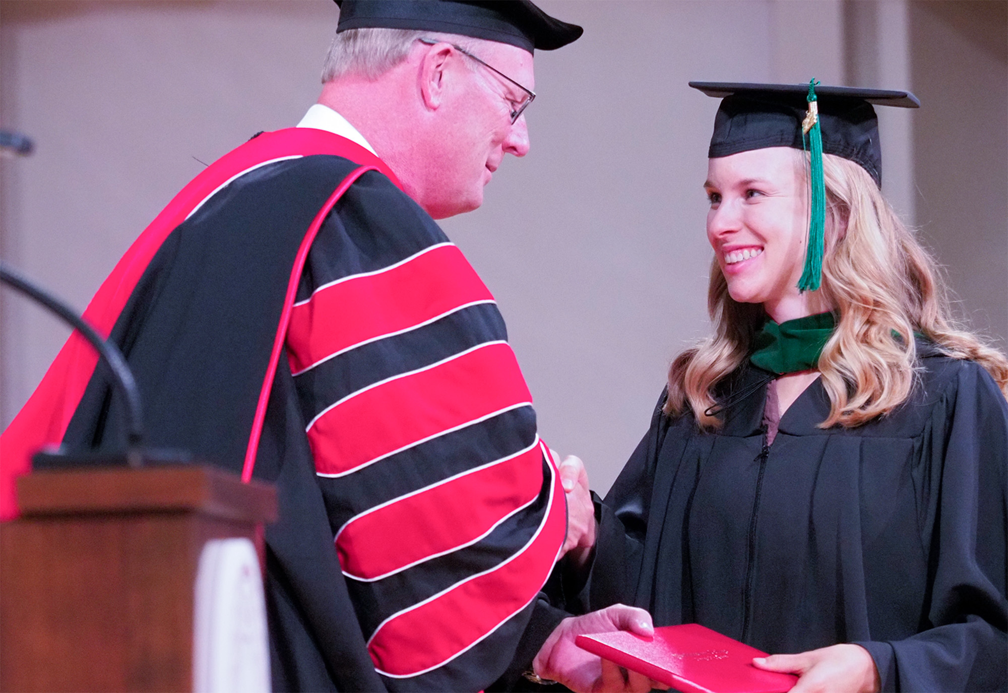 President Christy congratulates a graduate.